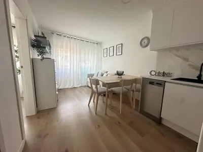a kitchen and dining room with a table and chairs at Beach apartment IV Coeur de Plage in Castelldefels