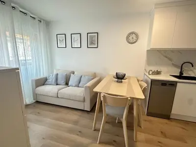 a living room with a table and a couch at Beach apartment IV Coeur de Plage in Castelldefels