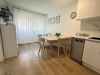 a kitchen and dining room with a table and chairs at Beach apartment IV Coeur de Plage in Castelldefels