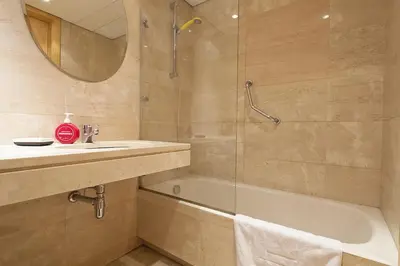 a bathroom with a tub and a sink and a shower at Spacious Duplex in Barcelona with outdoor terrace - 180 m² in Barcelona