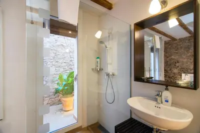 a bathroom with a sink and a mirror at Happy People Ramblas Harbour Apartments in Barcelona