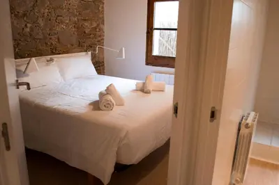 a bedroom with a white bed with towels on it at Happy People Ramblas Harbour Apartments in Barcelona