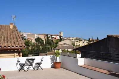 a group of chairs sitting on top of a roof at Casa Le Bouganville in Sant Vicenç de Montalt
