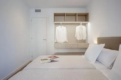 a bedroom with a bed with a book on it at LucasLand Apartments Barcelona in Barcelona
