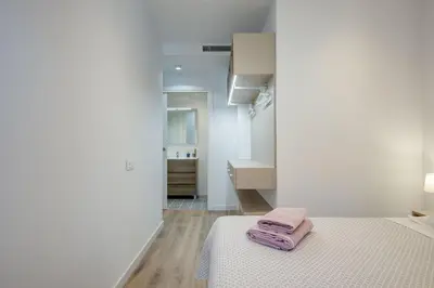 a bedroom with a bed with two towels on it at LucasLand Apartments Barcelona in Barcelona
