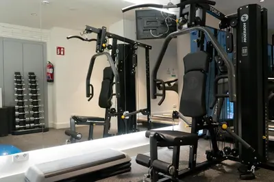 a gym with several tread machines in front of a mirror at Occidental Diagonal 414 in Barcelona