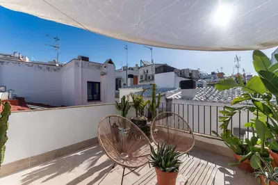 a balcony with two chairs and some plants at Casa Azul by Hello Homes Sitges in Sitges