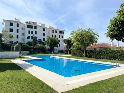 a swimming pool in front of a building at Vistas Del Mar by Hello Homes Sitges in Sitges