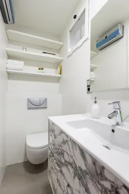 a white bathroom with a sink and a toilet at Art House Paral-lel Sant Antoni in Barcelona