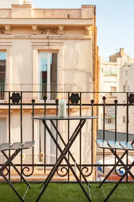 a table and two chairs on a balcony at Art House Paral-lel Sant Antoni in Barcelona