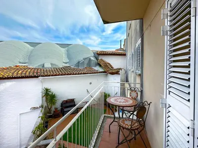 a balcony with a table and chairs on a building at Sunlight by Hello Homes Sitges in Sitges