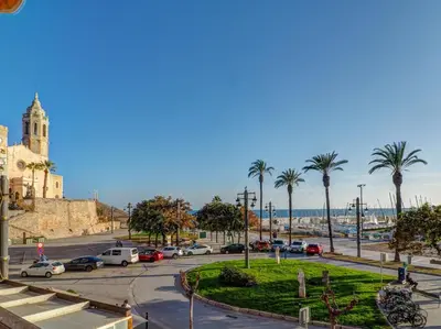 a street with cars parked in a parking lot at Soleil by Hello Homes Sitges in Sitges