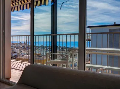 a room with a balcony with a view of the ocean at Diamond by Hello Homes Sitges in Sitges