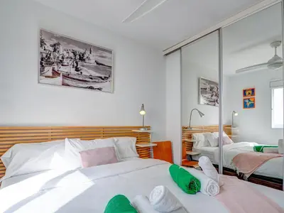 a bedroom with two beds and a mirror at Marina Duplex by Hello Homes Sitges in Sitges