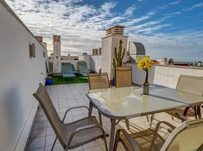 a patio with a table and chairs on a balcony at Mimosa Apartment by Hello Homes Sitges in Sitges