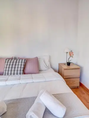 a living room with a white couch and a table at Mimosa Apartment by Hello Homes Sitges in Sitges