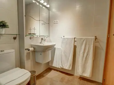 a bathroom with a toilet and a sink at Mimosa Apartment by Hello Homes Sitges in Sitges