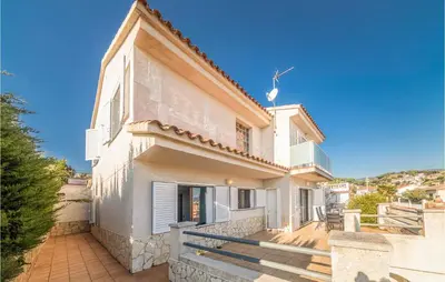 a large white house with a porch and stairs at Gorgeous Home In Sant Cebrià De Vallalt in San Cipriano de Vallalta