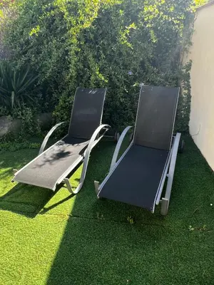 two chairs sitting on the grass in a yard at ALOJAMIENTO CON JARDIN 20KM BARCELONA in Vilassar de Dalt