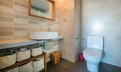 a bathroom with a white toilet and a sink at Magnificent apartment close to the beach in Barcelona