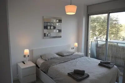 a bedroom with a bed with two towels on it at Magnificent apartment close to the beach in Barcelona