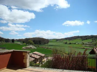 a view of a lush green field from a house at Can Vilafort in Collsuspina