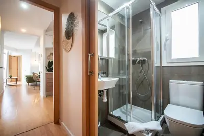 a bathroom with a shower and a toilet and a sink at You Stylish Sagrada Familia Apartments in Barcelona