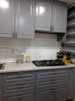 a kitchen with a stove top and white cabinets at Nur Apartment in Terrassa