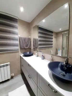 a bathroom with a sink and a large mirror at Nur Apartment in Terrassa