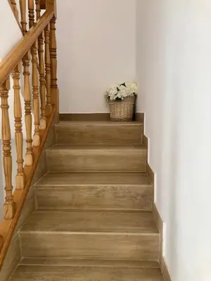 a stairway with a basket of flowers in a room at Vilamarlux IV in Vilassar de Mar