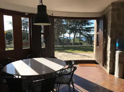 a dining room with a white table and chairs at Casa Vila Reyes in Sant Vicenç de Montalt