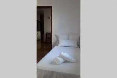 a bedroom with a white bed with towels on it at Chopin Magic Fountain in Barcelona