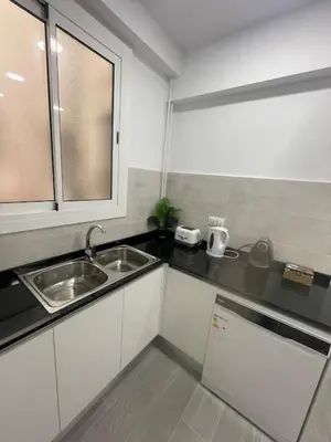 a kitchen with a sink and a counter top at Family-Friendly Home in Central Barcelona 4BDR in Barcelona