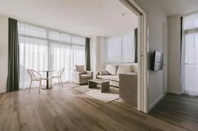 a living room with a couch and a table at CIM Aparthotel in Sant Cugat del Vallès