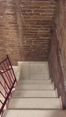 a staircase in a brick building with a metal railing at Easystaybcn2 in Barcelona