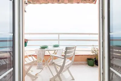 a table and chairs on a balcony with a view of the ocean at Apartment in front of the Beach in Pineda de Mar