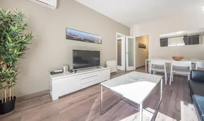 a living room with a flat screen tv on the wall at You Stylish El Born Apartments in Barcelona
