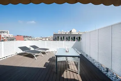 a balcony with a table and chairs on a roof at You Stylish El Born Apartments in Barcelona