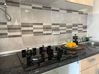 a kitchen counter with a stove and a plate of oranges at Amazing Badalona Apartment With Terrace in Badalona