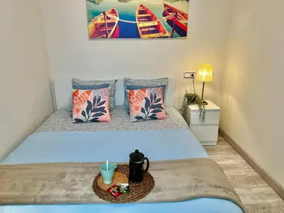 a bedroom with a bed with a candle on it at Amazing Badalona Apartment With Terrace in Badalona