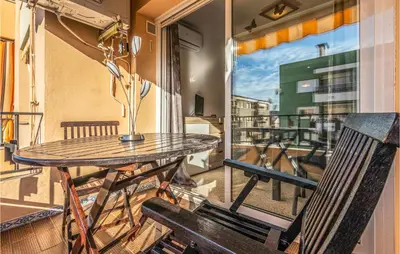 a balcony with a table and a chair at Gorgeous Apartment In Pineda De Mar in Pineda de Mar