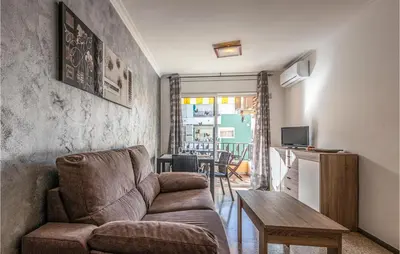 a living room with a couch and a table at Gorgeous Apartment In Pineda De Mar in Pineda de Mar