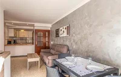 a living room with a table and a couch at Gorgeous Apartment In Pineda De Mar in Pineda de Mar