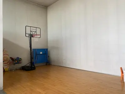 a basketball hoop in a room with a wooden floor at Can Ramón in Caldes de Montbui