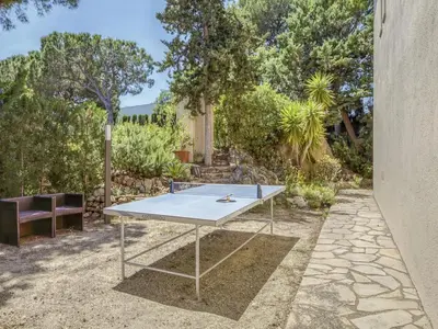 a ping pong table with a tennis racket on it at Villa in Arenys de Mar with Sea View in Arenys de Mar
