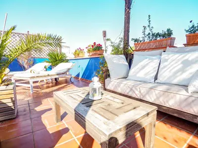a patio with a couch and a coffee table at Montroig Zen Penthouse by Hello Homes Sitges in Sitges