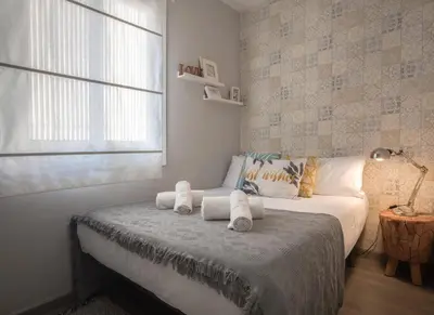a bedroom with a bed with towels on it at Stay Unique Apartments Aprestadora in Hospitalet de Llobregat