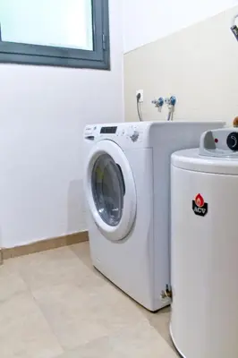 a washing machine in a bathroom with a window at Urban Manesa city center apartment with private patio in Manresa