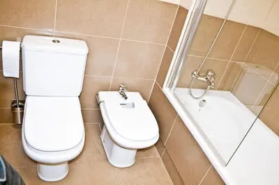 a bathroom with a toilet and a bath tub at Urban Manesa city center apartment with private patio in Manresa