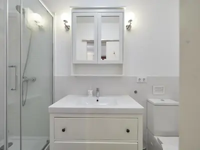 a white bathroom with a sink and a shower at BarcelonaForRent Alessandra Ramblas in Barcelona